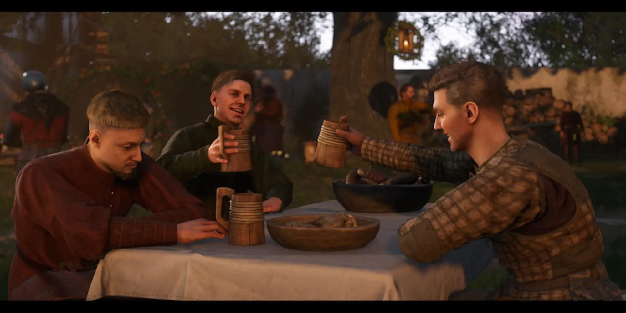 Các nhân vật trong Kingdom Come Deliverance 2 đang cùng nhau ăn uống, trò chuyện vui vẻ trong một quán rượu thời Trung Cổ.