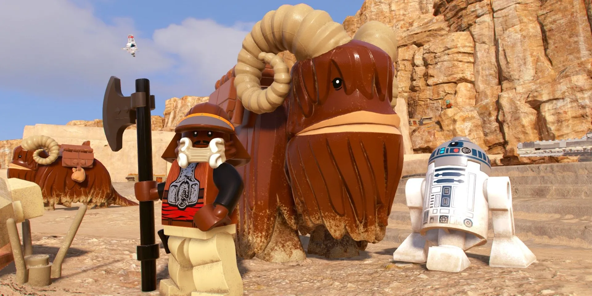 R2D2 và Lando đứng cạnh một con Bantha trong LEGO Star Wars The Skywalker Saga