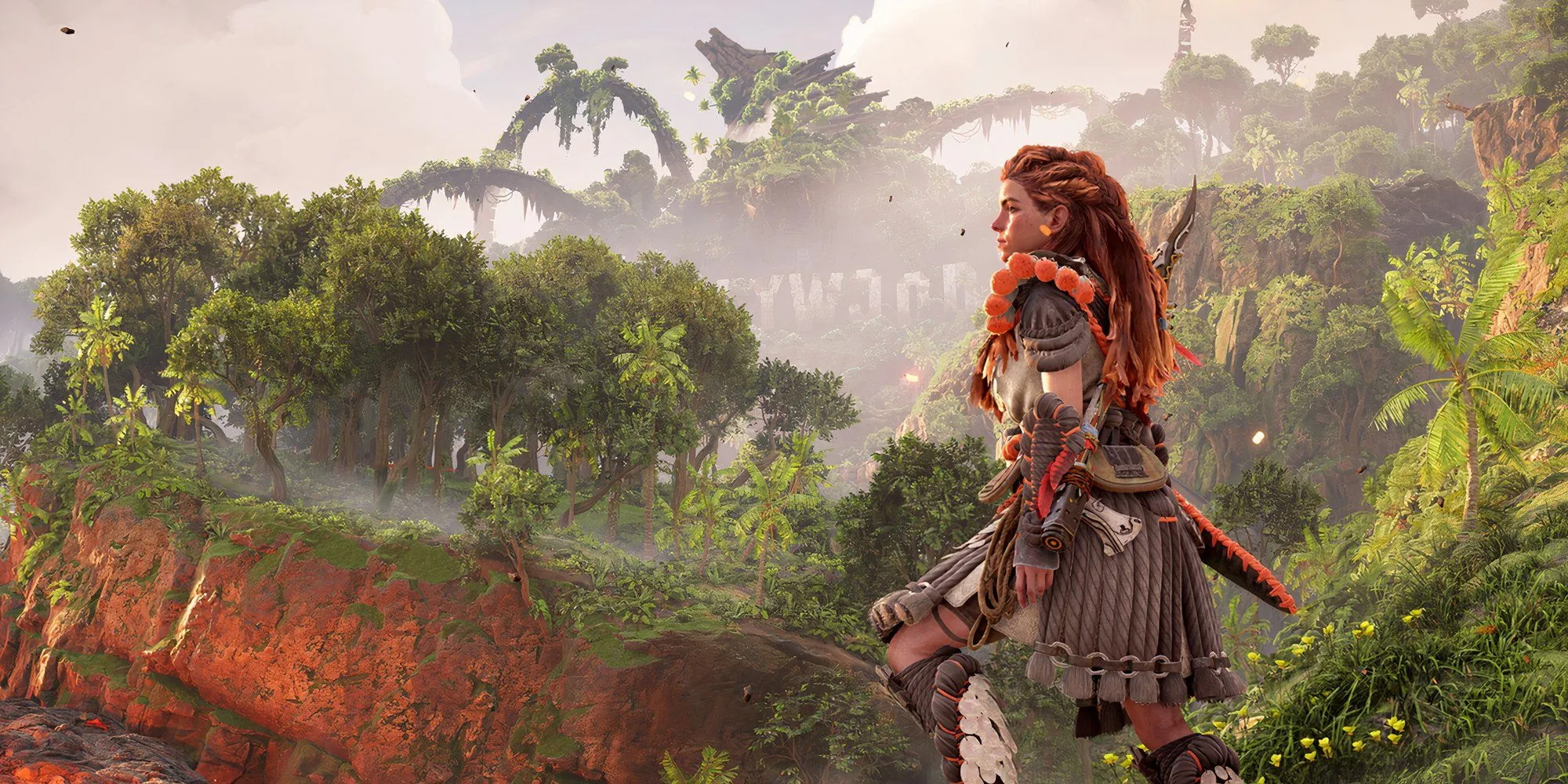 Aloy đứng giữa cảnh quan ngoài trời trong game Horizon Forbidden West