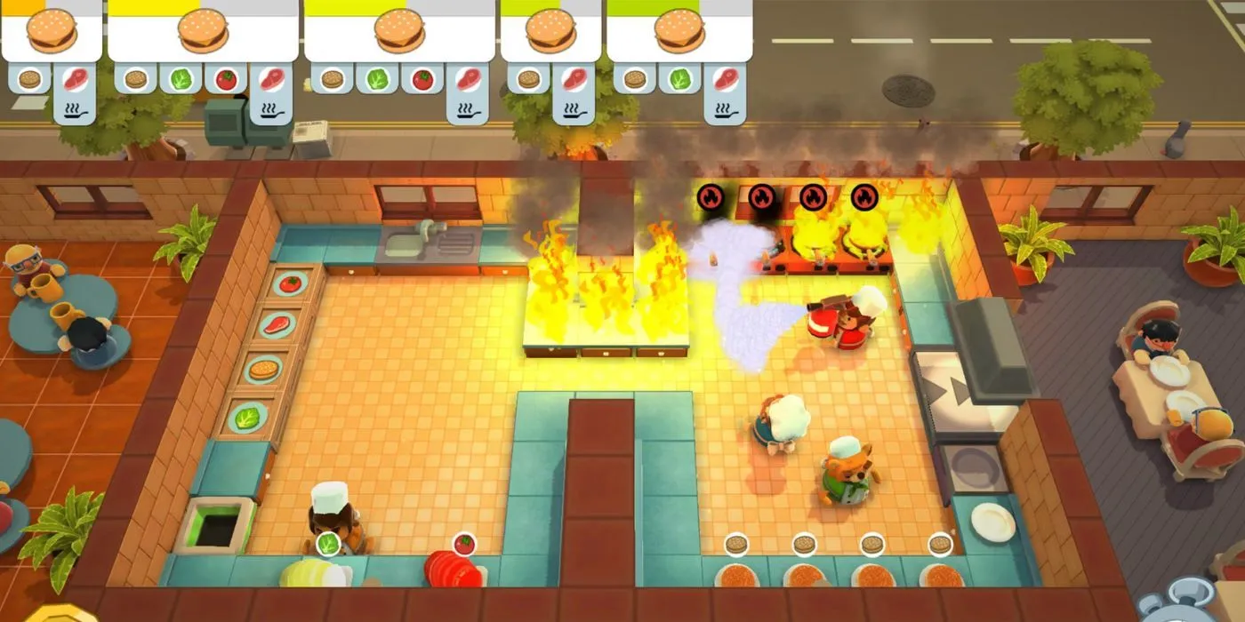 Cảnh hỗn loạn trong nhà bếp Overcooked với lửa cháy và nhiều đồ ăn.