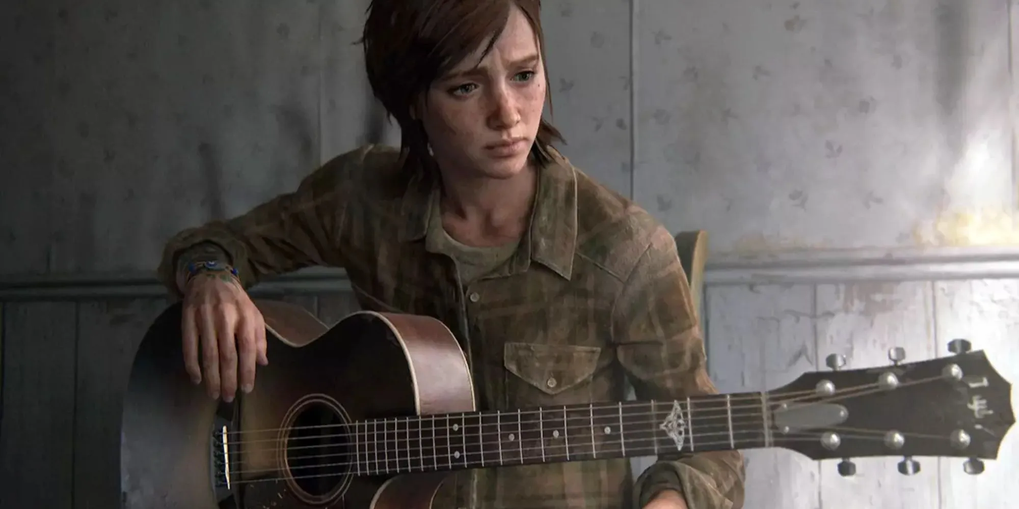 Ellie chơi guitar với bàn tay bị thương ở cuối The Last of Us Part 2, biểu tượng cho sự mất mát và đau khổ tinh thần.