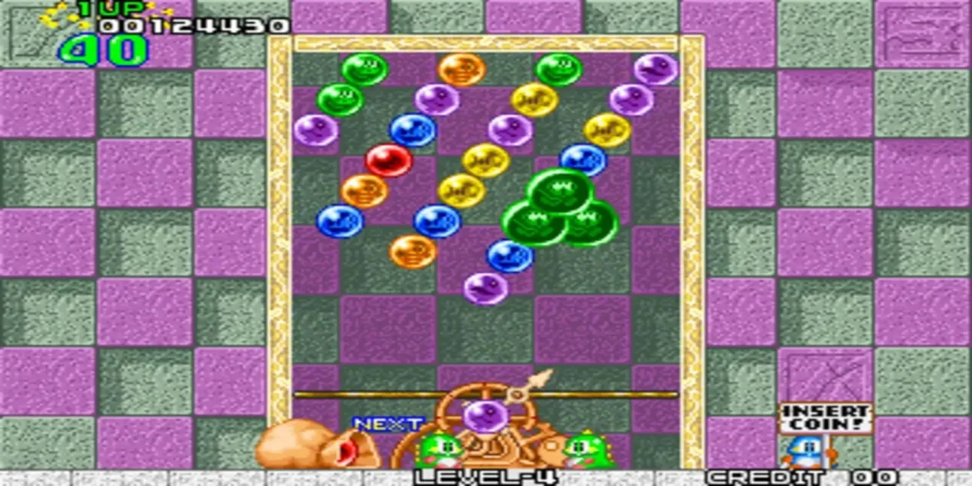 Màn hình game Bust a Move trên PS1, hiển thị các chú khủng long và những quả bóng màu sắc