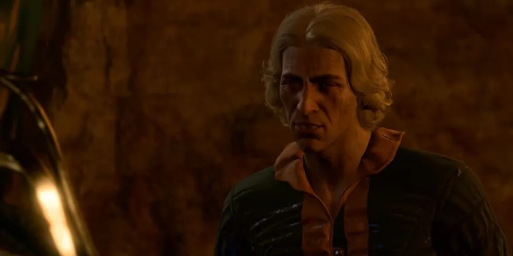 Oskar Fevras, họa sĩ bị bắt giữ trong Baldur's Gate 3, đang ngồi co ro trong lồng giam tại Hầm Zhentarim